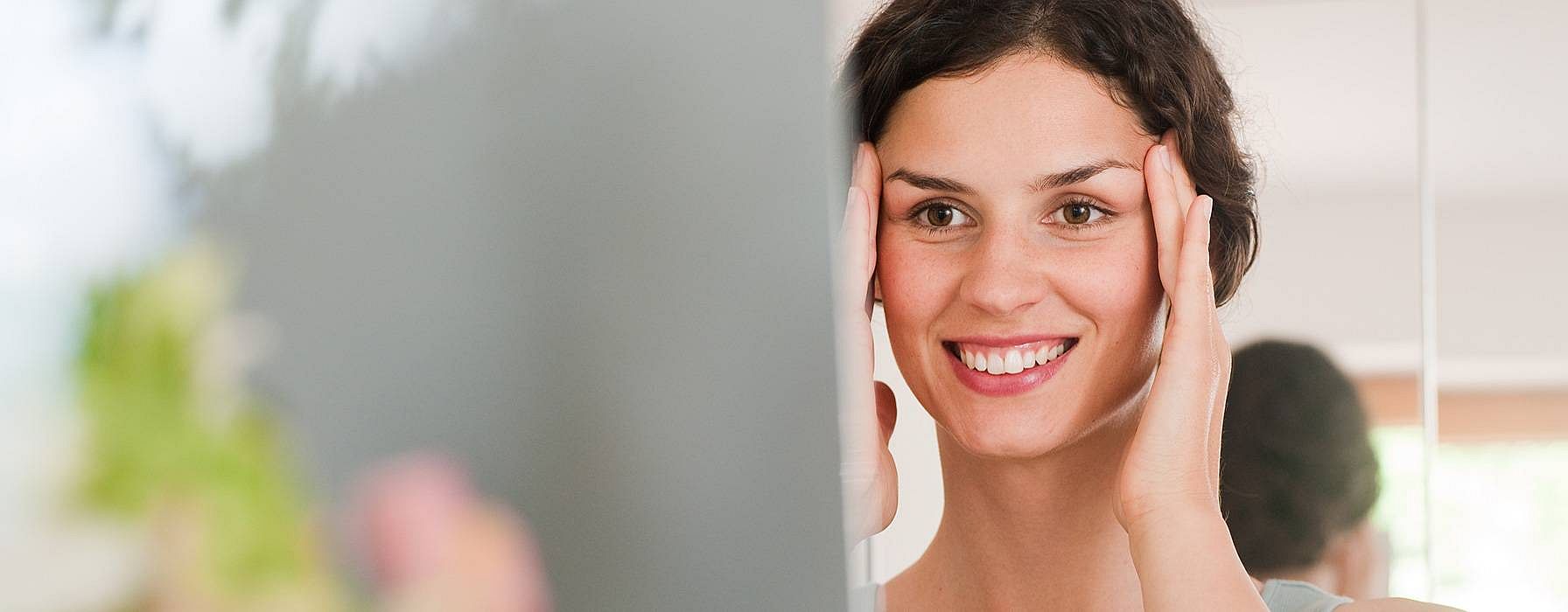 Woman giving herself a Soothing Facial Massage
