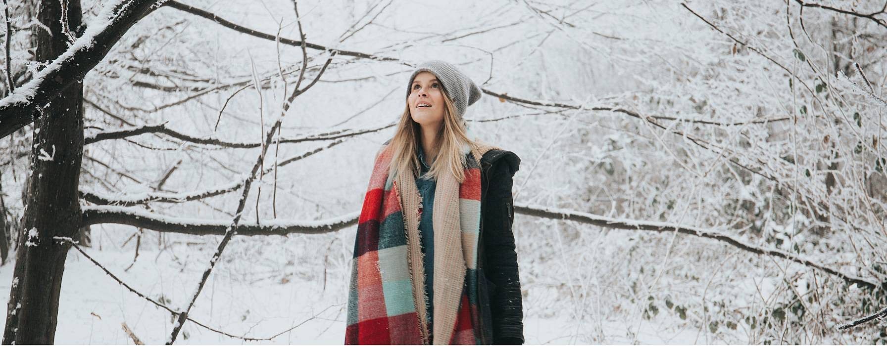 woman standing in woods in winter