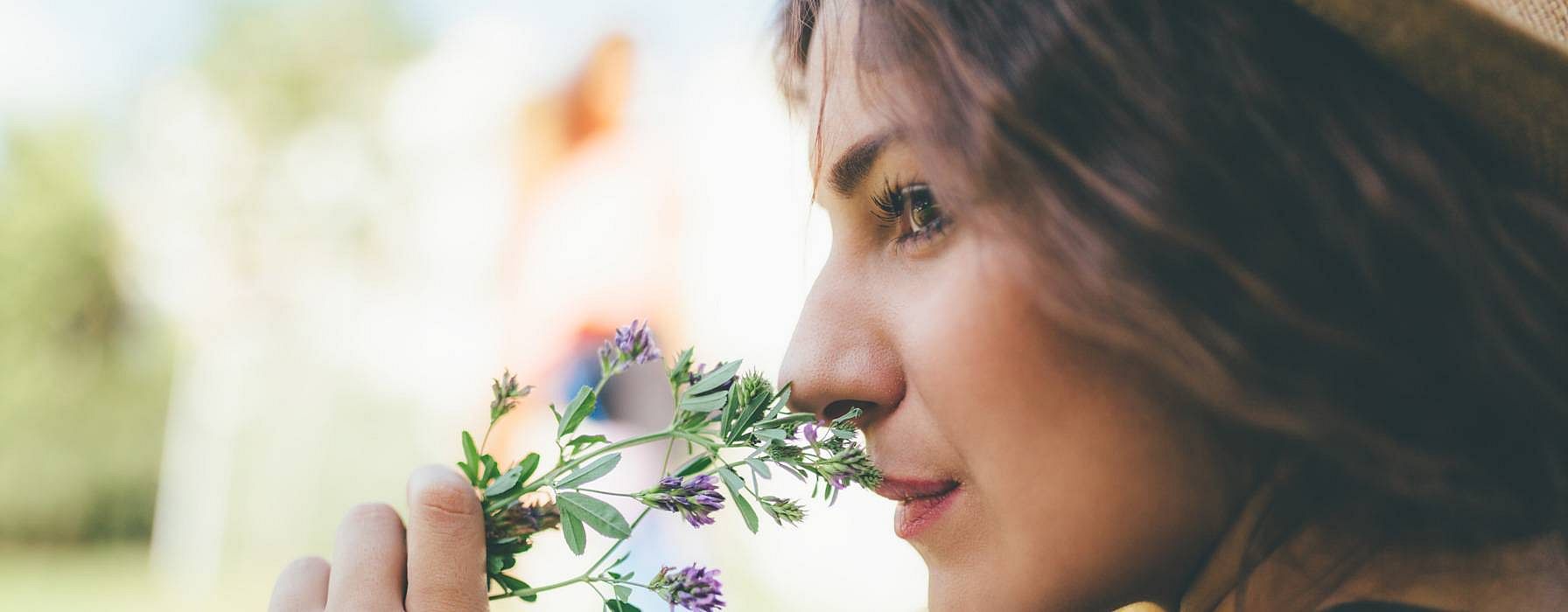 woman smelling a flower
