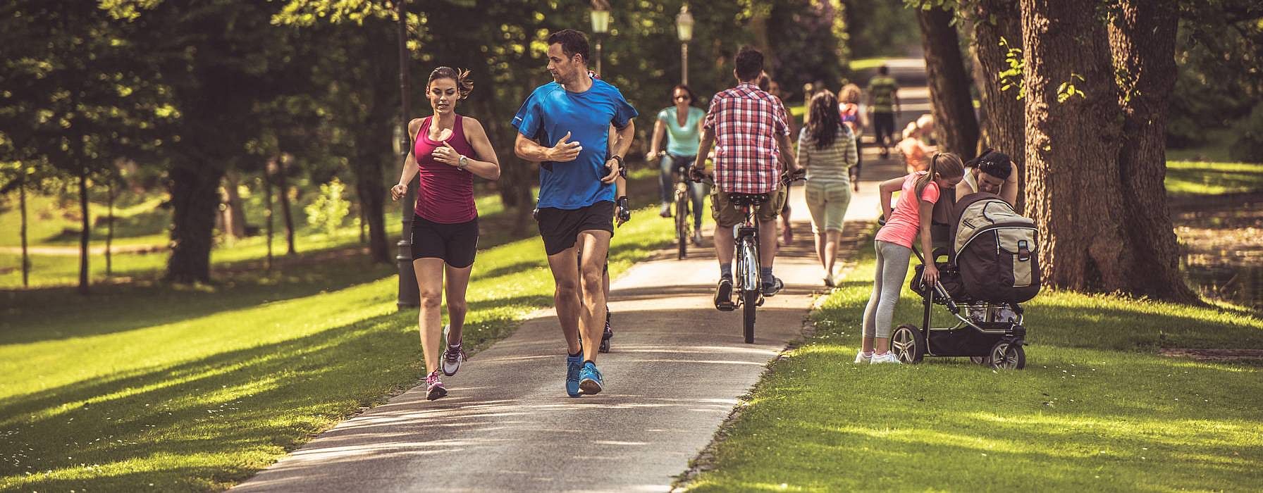 people in park, running, walking and biking