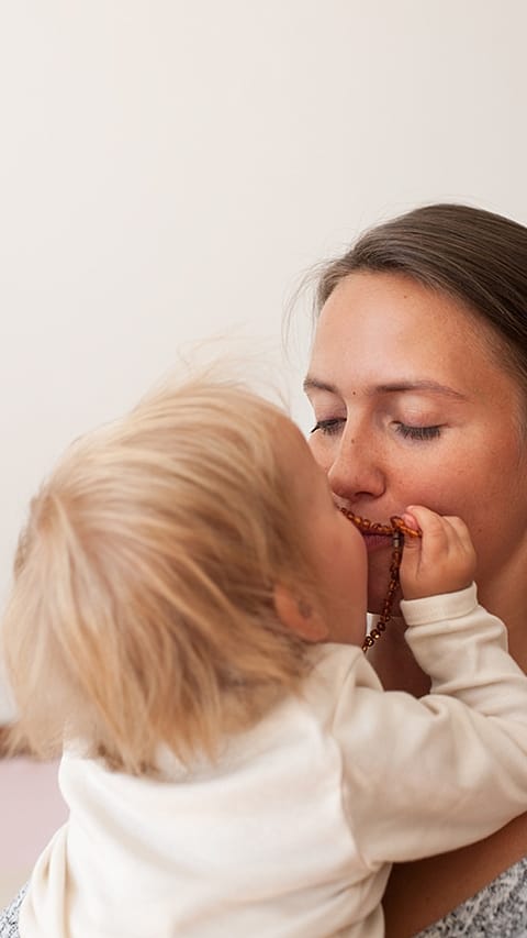 Baby kissing mother