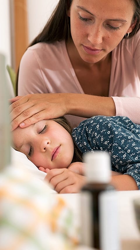 Sick child in mothers lap