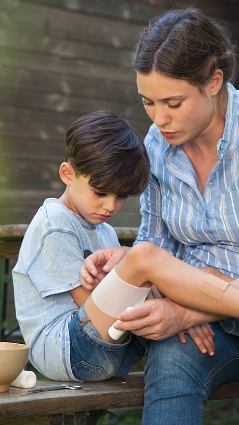 mother caring for boy with bruises