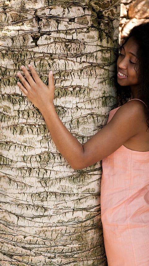 Woman hugging a tree
