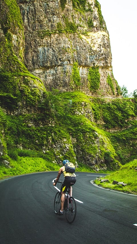 man biking on road