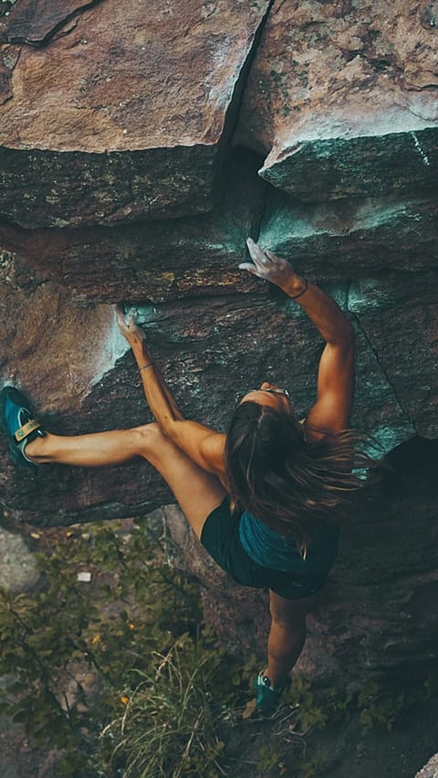woman climbing a mountain