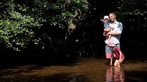 Father with 2 children by the water