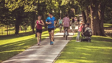 people in park, running, walking and biking