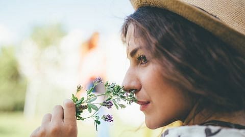 woman smelling a flower