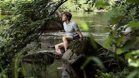 Man on rocks by lake