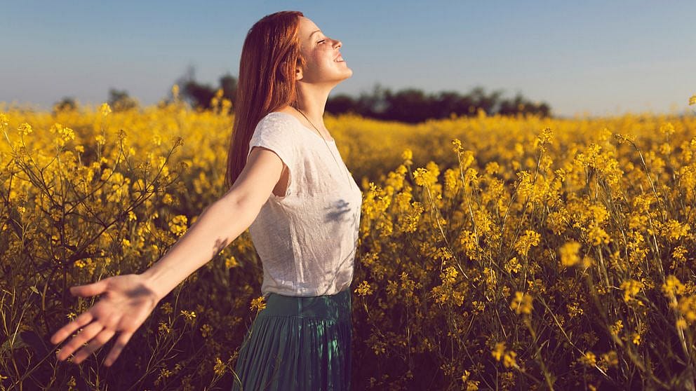 Women in field with open arms