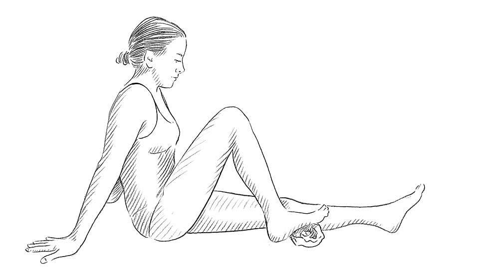 Step 1: While seated on the floor, place your foot close to your body