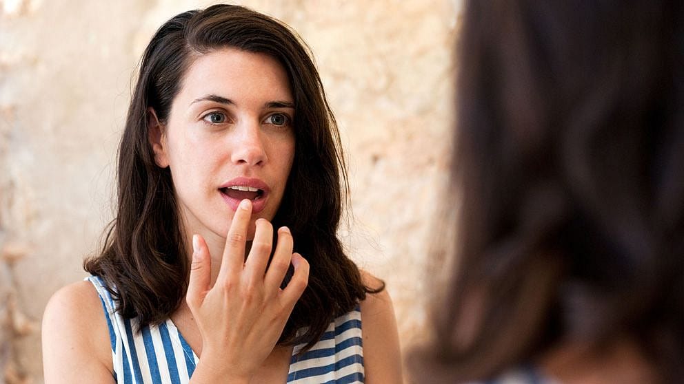 Woman applying Skin Food Lip Butter Nourishing Lip Care