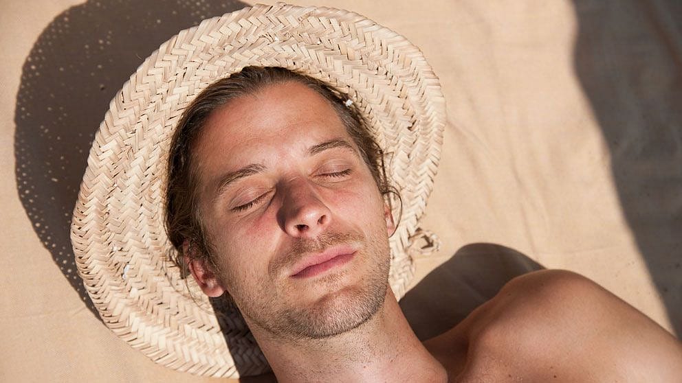 lying on the sand in the sun