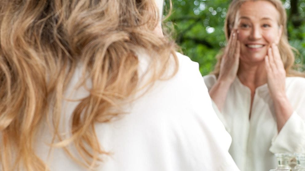 Woman applying Evening Primrose Age Revitalising Eye and Lip Cream along the lip line