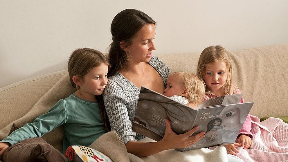 Mother reading to her 3 children