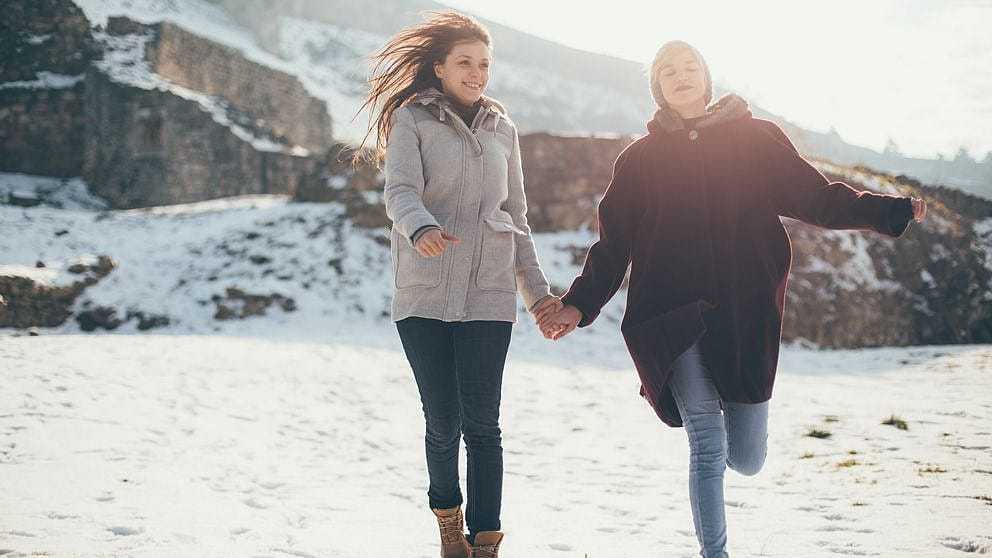 two friends walking in winter